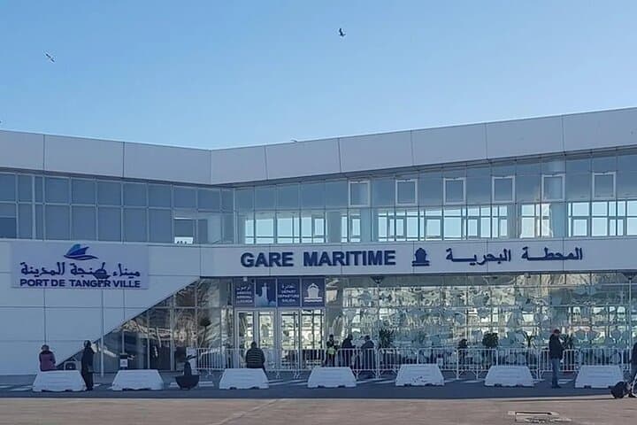 Exterior of the Port de Tanger Ville maritime station with people standing outside.